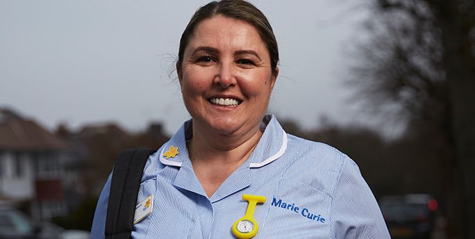 Marie Curie Nurse Daniela smiles as she poses for a photograph.