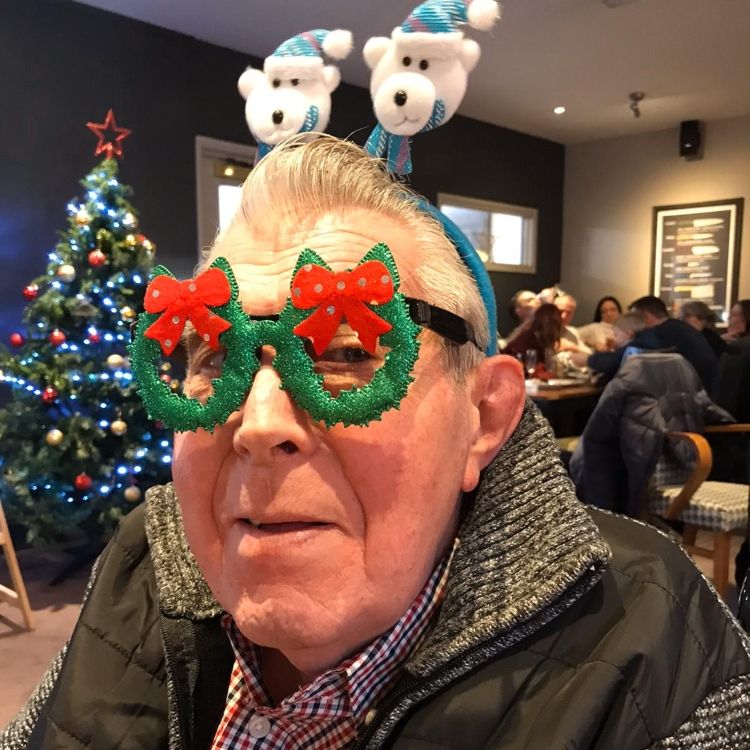 A man wearing novelty Christmas glasses