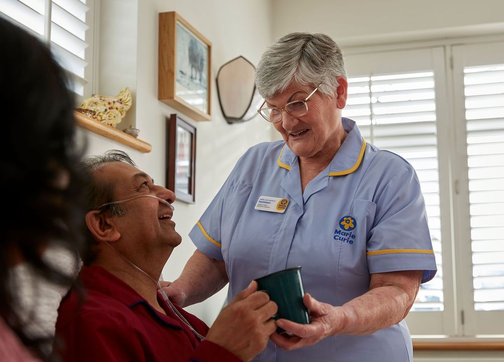 Marie Curie Nurse caring for a patient in their home