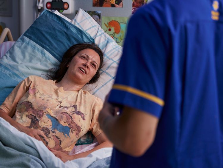 Patient in bed with nurse at bedside