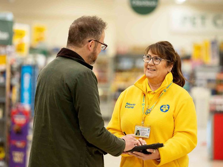 Fundraising volunteer talking to customer