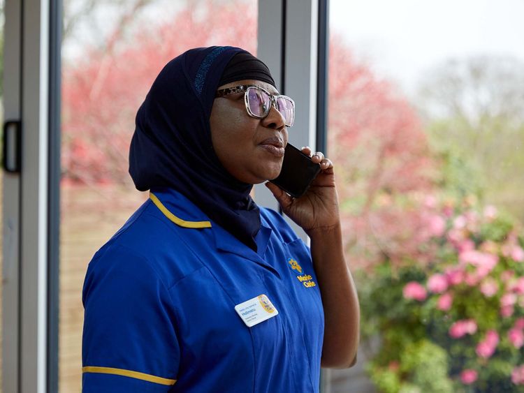 A healthcare professional in Marie Curie uniform calls the Support Line.