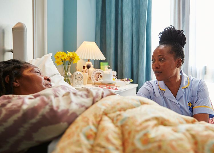 Patient in bed with nurse at bedside