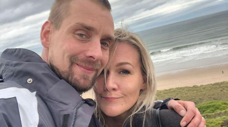 Joost and Stacey hugging and smiling on a wintry beach