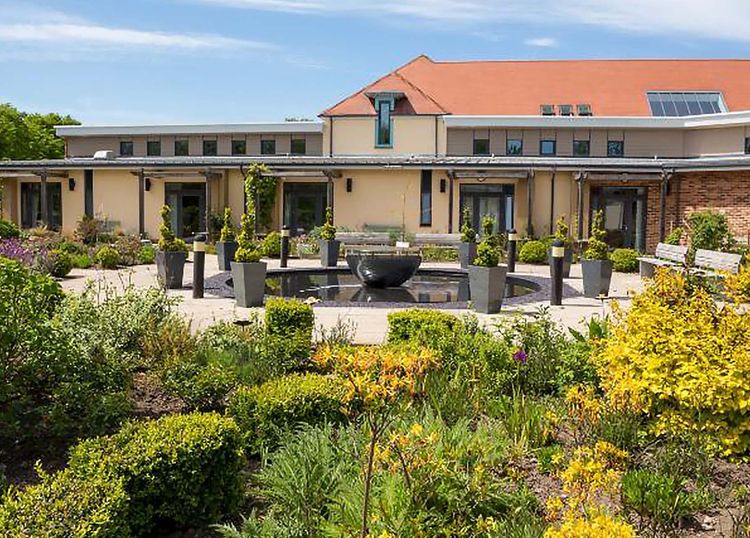 Exterior of a hospice building with a view of the hospice garden