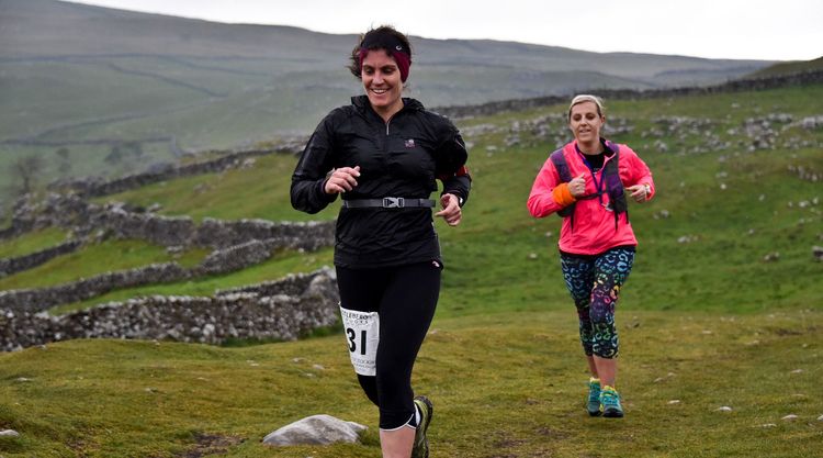 Dr Sarah Holmes running across moorland in winter