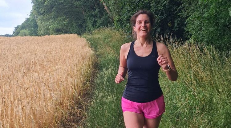 Dr Sarah Holmes running in a black top and shorts