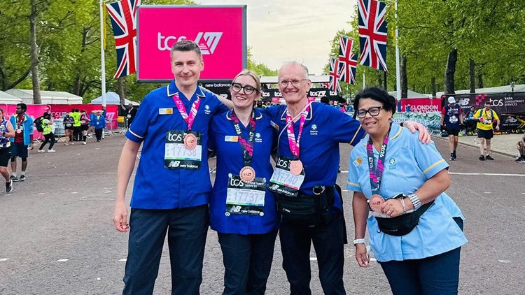 To The End Team posing with their marathon finisher's medals