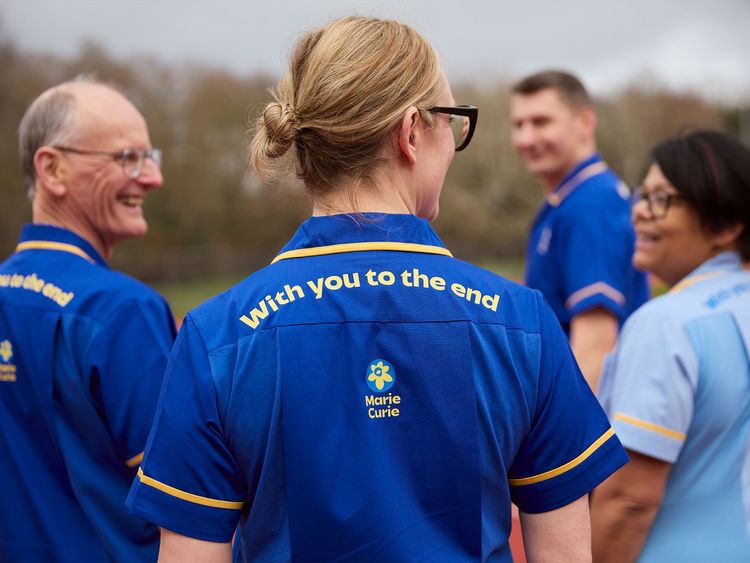 To The End team member of nursing staff with 'With you to the end' on the back of her tunic