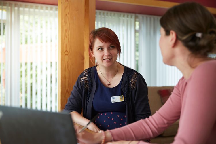 Cherie Barbour at work talking to a colleague