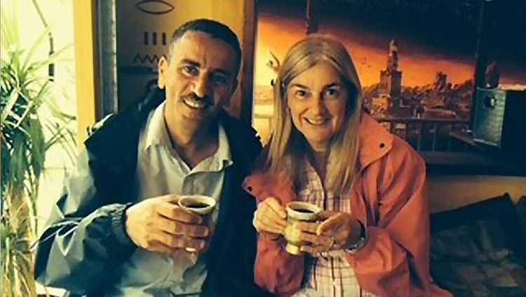 Francine and Fathi drinking tea together and smiling in earlier years