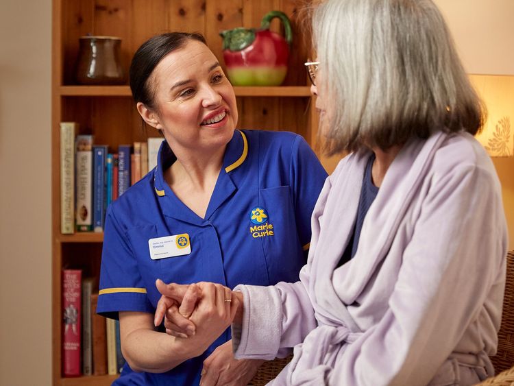 A Marie Curie Nurses talks to a patient
