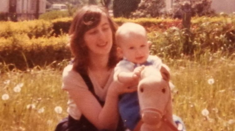Thomas as a baby on a toy horse with Mum Yvonne
