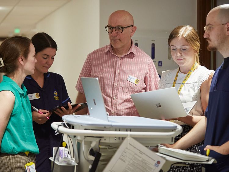 Five Marie Curie staff gather for a meeting