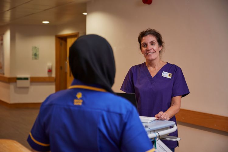 Dr Sarah Holmes stands talking to another member of clinical hospice staff at the Marie Curie Hospice, Bradford