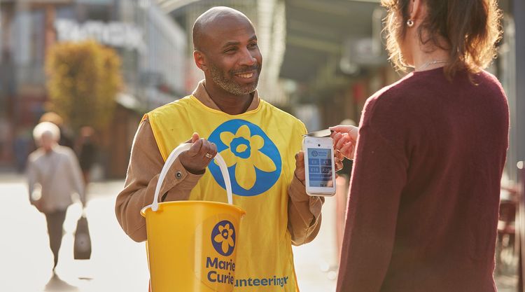 A volunteer collecting in the street